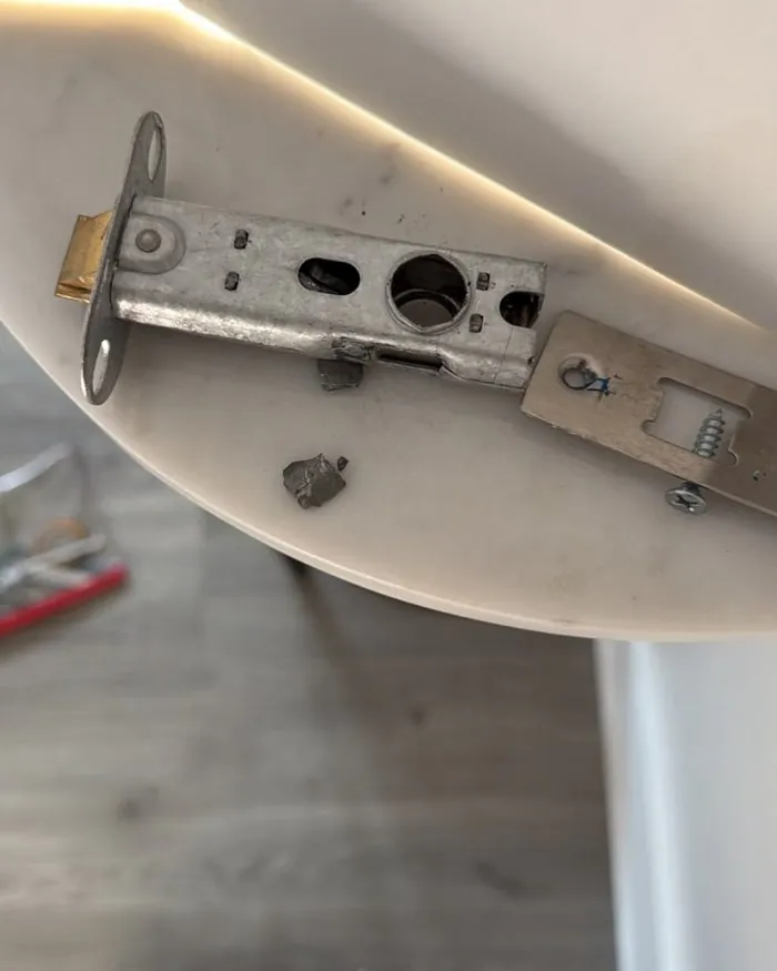 Broken tubular door latch with a snapped-off piece, removed from an internal door in Woodstock