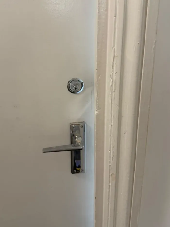 New key-operated lock and lever handle fitted to a room door in a student shared house in Witney