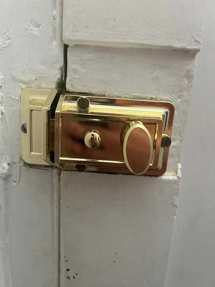 New polished brass traditional night latch fitted like for like on a painted door in Witney