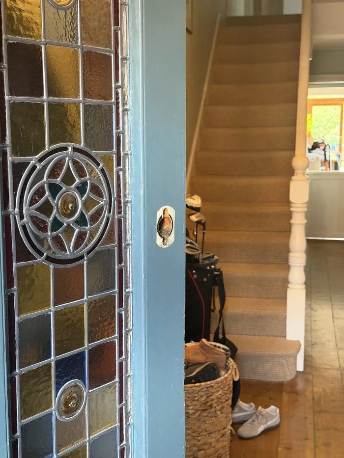 Old lock removed from a period front door with stained glass panels ahead of a lock change in Chipping Norton