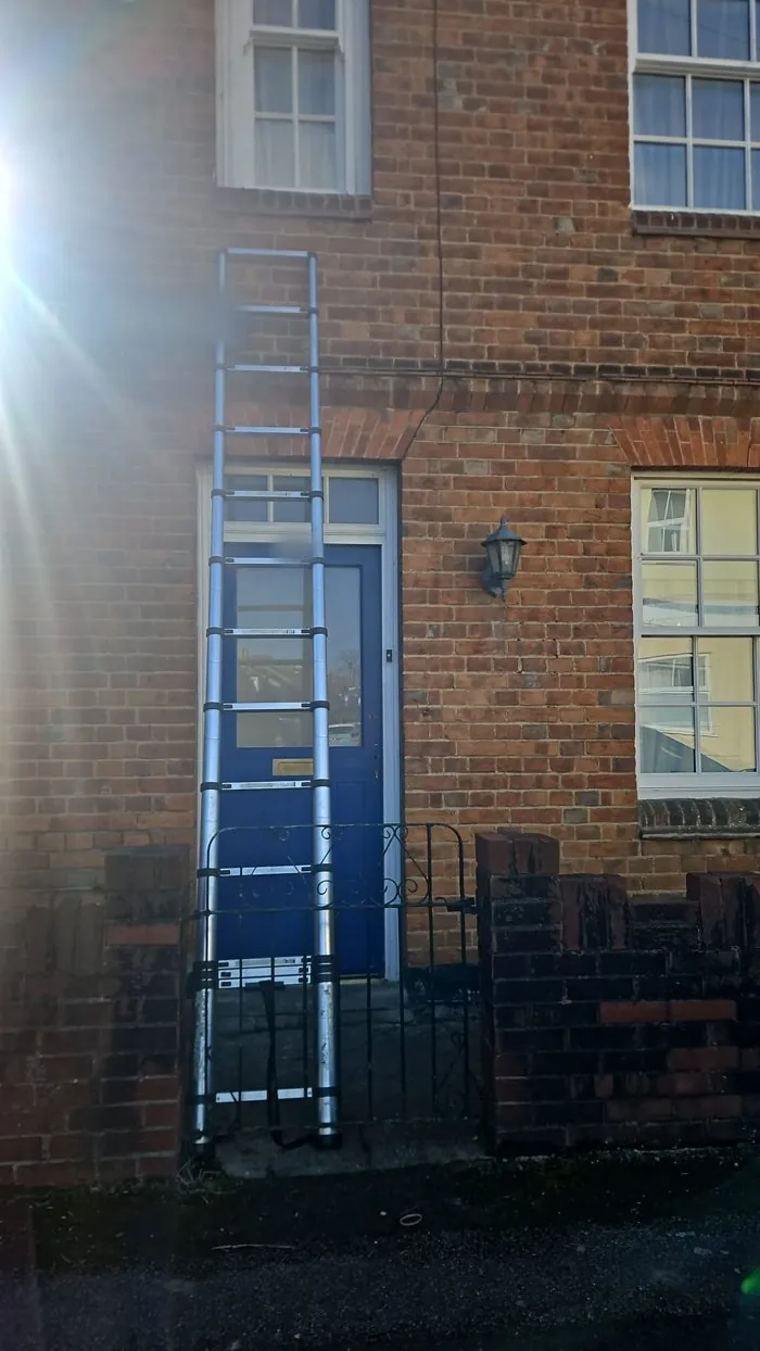 Ladder up to an upstairs window of a brick terraced house near Banbury, used to gain entry during a lockout
