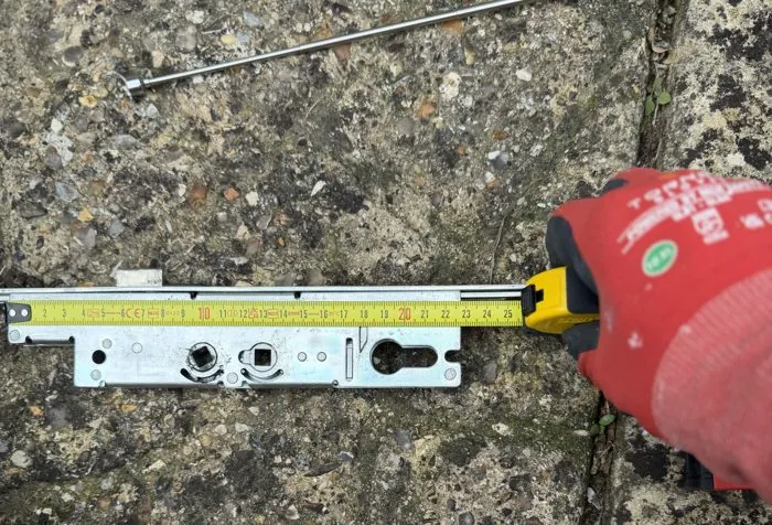 Faulty uPVC multi-point lock gearbox being measured for an exact replacement, Bicester
