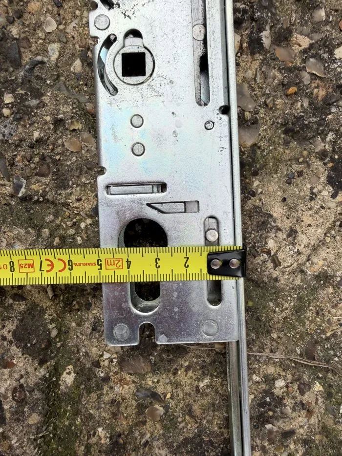 Close-up of a faulty uPVC multi-point lock gearbox being measured for replacement in Bicester