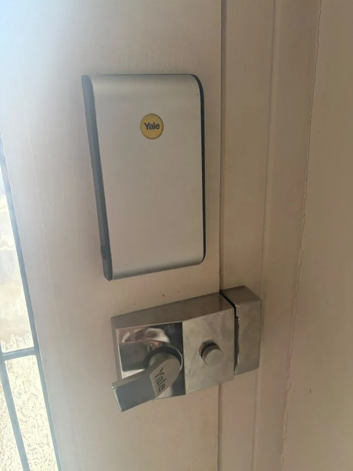Yale smart lock keyless entry system fitted to a white front door in Banbury